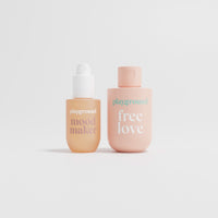 Two pink bottles labeled 'mood maker' and 'free love' on a light gray background