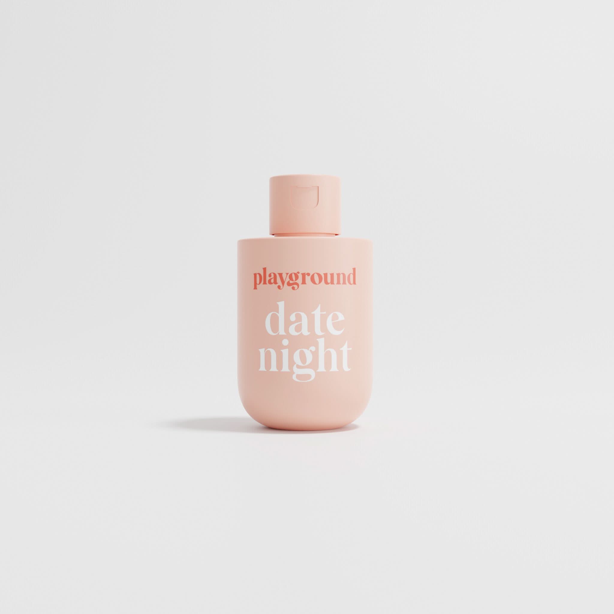 Pink bottle labeled 'playground date night' on a light gray background