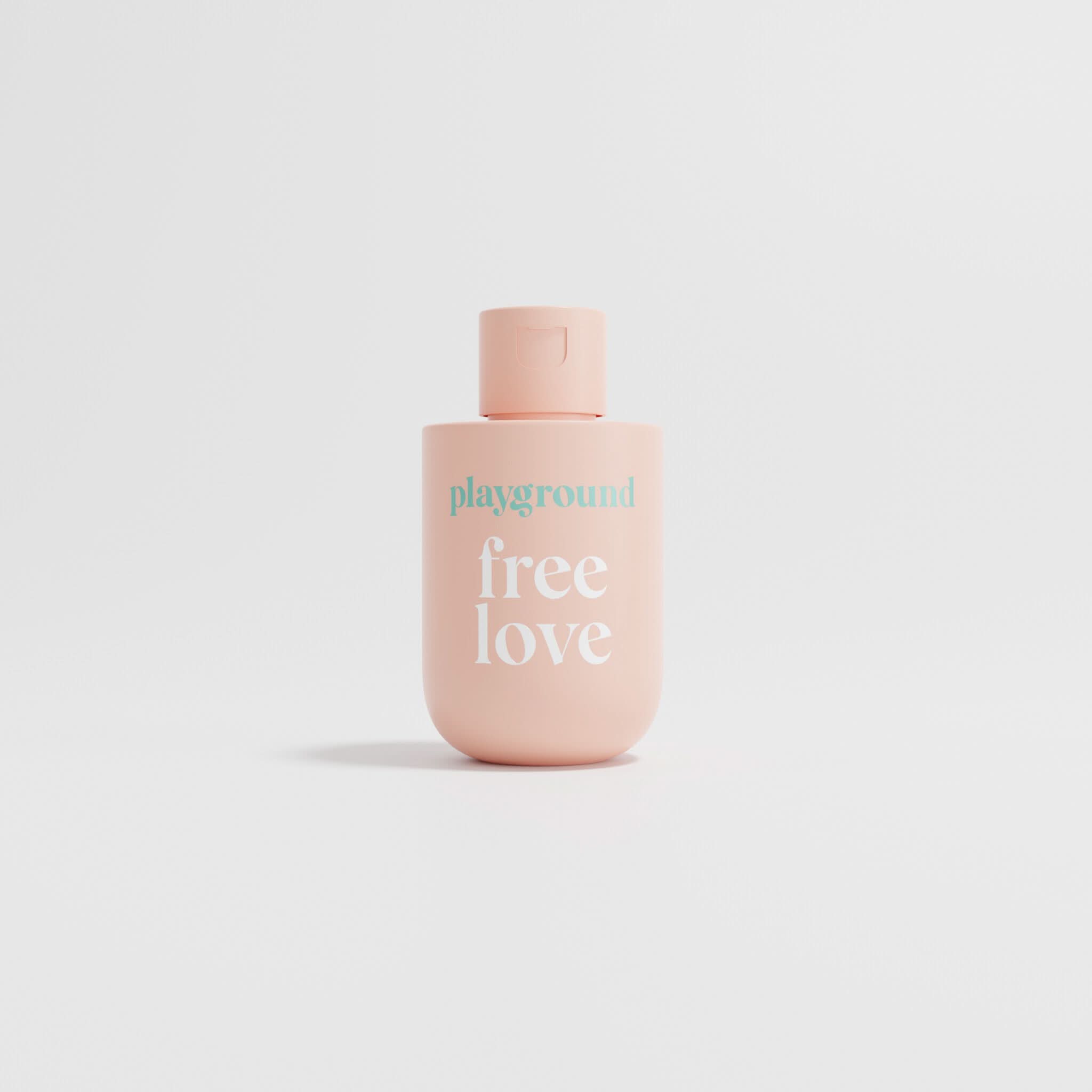 Pink bottle with 'playground free love' text on a light gray background