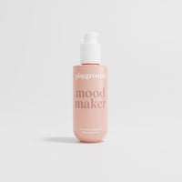 Bottle of 'mood maker' oil by 'playground' on a light gray background
