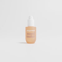 Bottle labeled 'playground mood maker' on a light gray background
