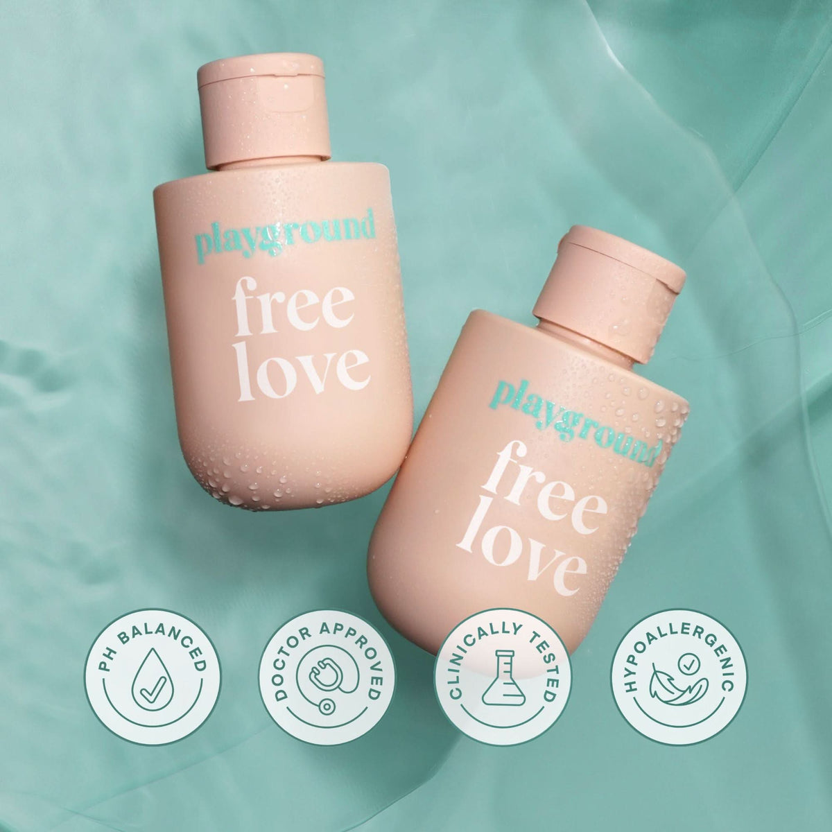 Two 'playground' bottles labeled 'free love' on a teal background with certification icons.