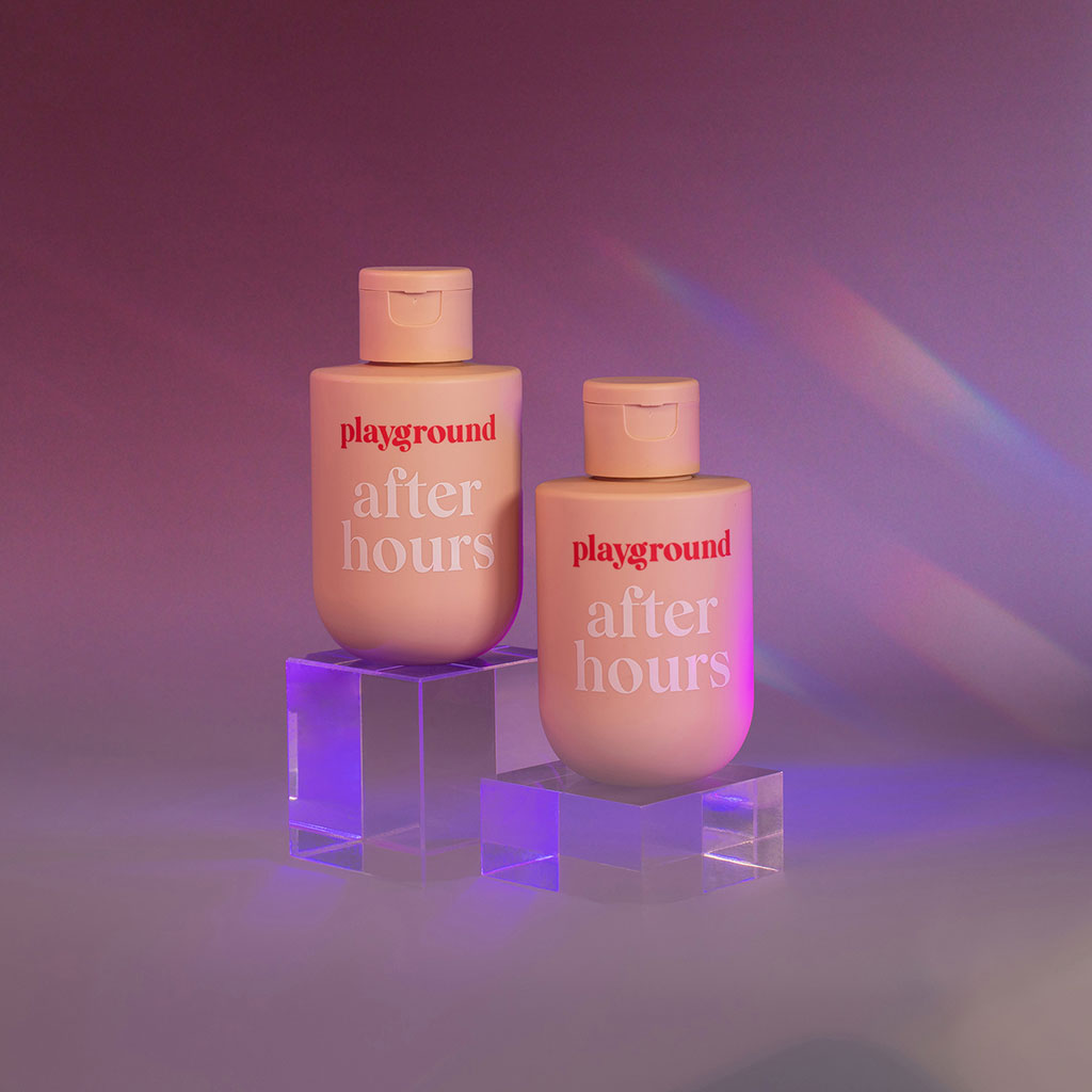 Playground After Hours water-based personal lubricant in a full-sized bottle on a smokey stylized background